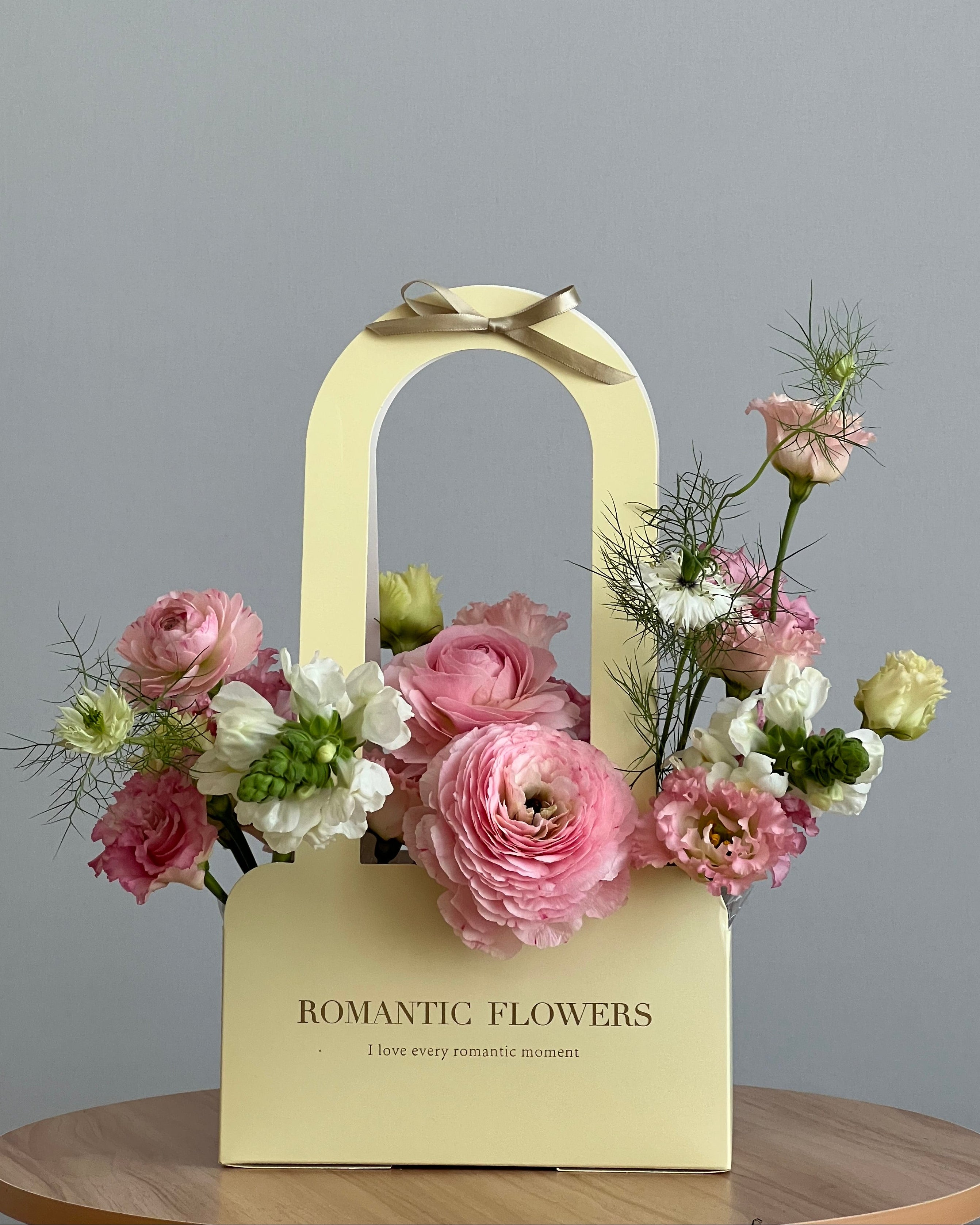 Floral arrangement on a yellow box with 'Romantic Flowers' text against a gray background